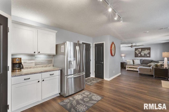 1708 Westport Dr, Davenport, IA 52804 - kitchen featuring ceiling fan, stainless steel fridge, white cabinetry, open floor plan, and visible vents