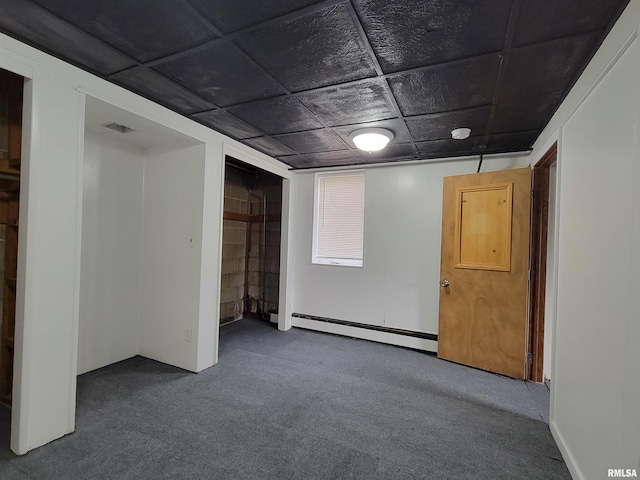 carpeted spare room with baseboard heating