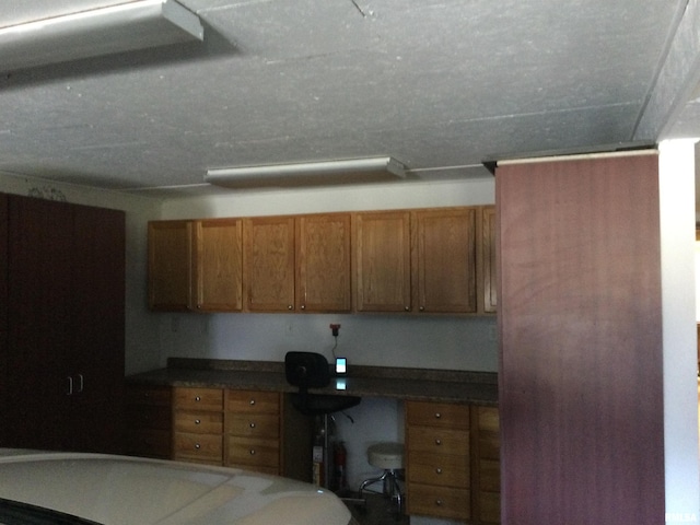 5453 Cherokee Ln, Carbondale, IL 62901 - kitchen with brown cabinets, built in study area, and dark countertops