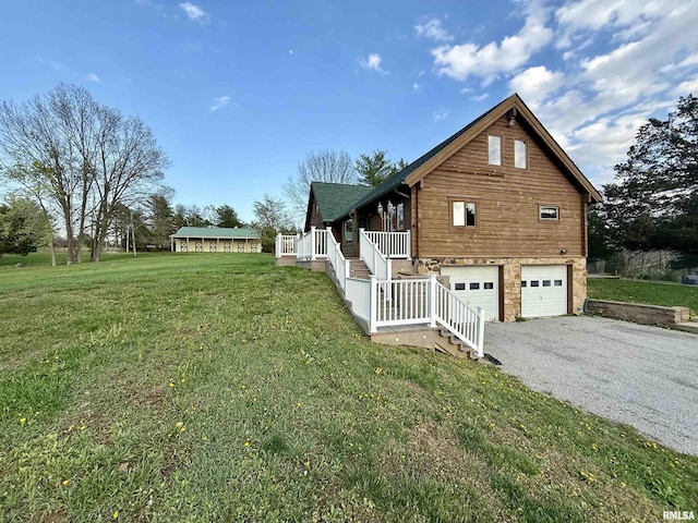 5453 Cherokee Ln, Carbondale, IL 62901 - view of home's exterior with driveway, stone siding, an attached garage, a yard, and covered porch