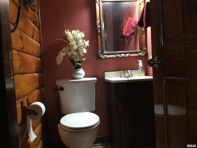 5453 Cherokee Ln, Carbondale, IL 62901 - half bathroom with toilet, vanity, and wallpapered walls