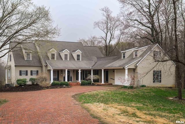 4996 Andrew Rd, Marion, IL 62959 - cape cod home with covered porch, a garage, driveway, and a front yard