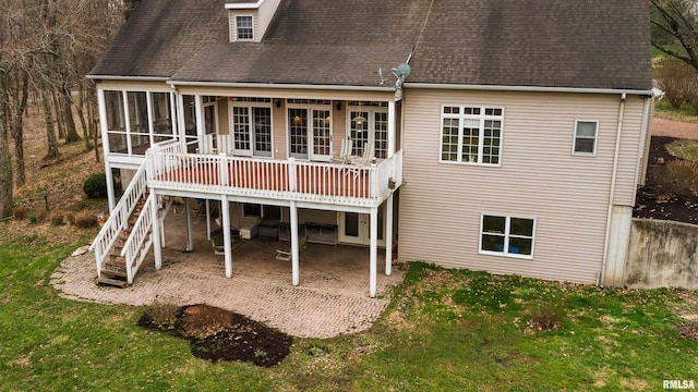 4996 Andrew Rd, Marion, IL 62959 - back of property with a sunroom, a lawn, a patio area, roof with shingles, and a wooden deck