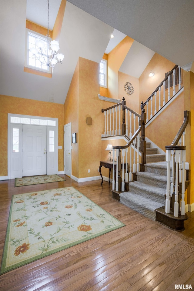 4996 Andrew Rd, Marion, IL 62959 - foyer featuring a towering ceiling, a chandelier, stairs, and wood finished floors