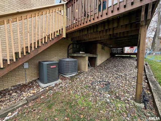 exterior space with brick siding and cooling unit