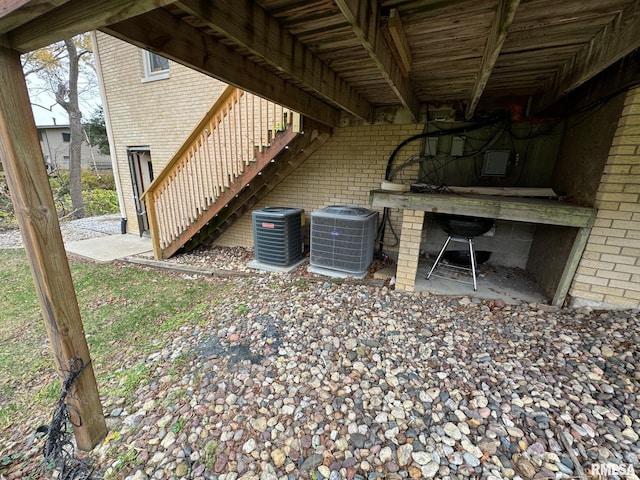 exterior space with stairs and central air condition unit
