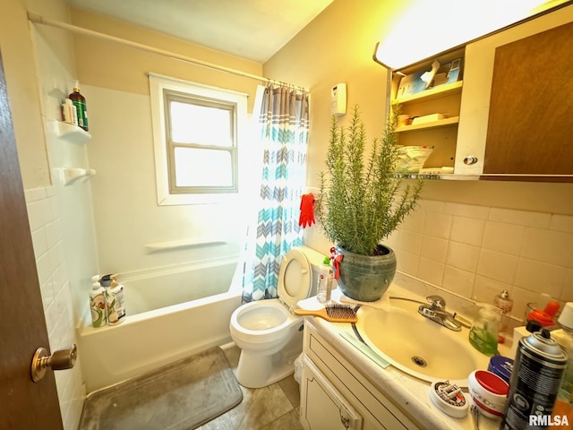 full bath with vanity, toilet, shower / tub combo with curtain, tile walls, and tile patterned floors