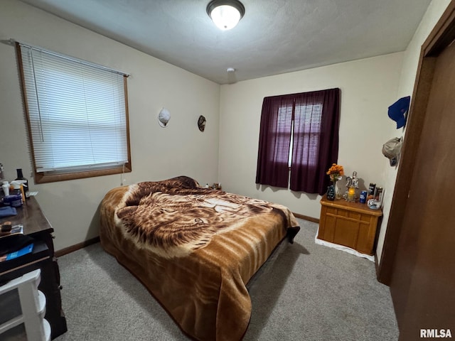 carpeted bedroom with baseboards