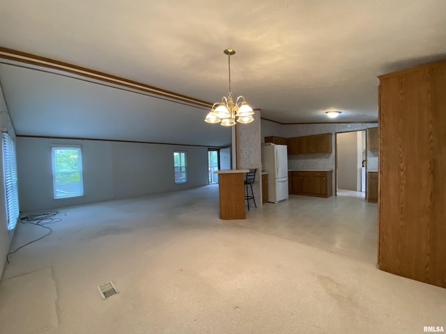 100 Little John Loop, Tunnel Hill, IL 62972 - kitchen featuring white appliances, a chandelier, light countertops, brown cabinetry, and decorative light fixtures