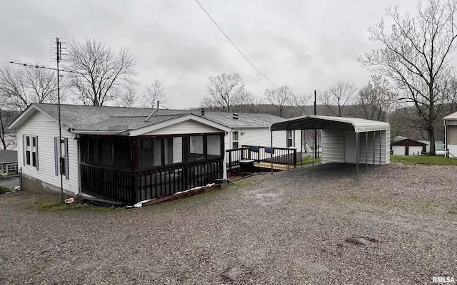 100 Little John Loop, Tunnel Hill, IL 62972 - rear view of house with a detached carport, a sunroom, driveway, and a shingled roof