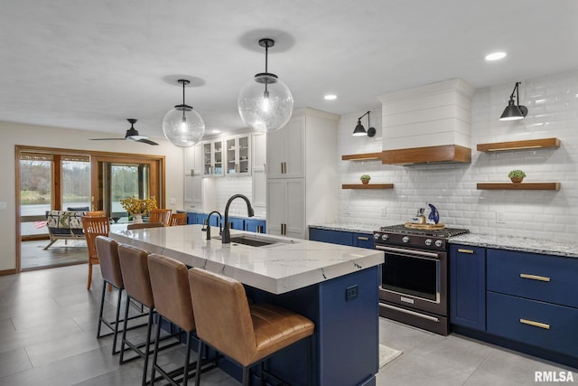 kitchen featuring a sink, white cabinetry, a ceiling fan, recessed lighting, and light stone countertops