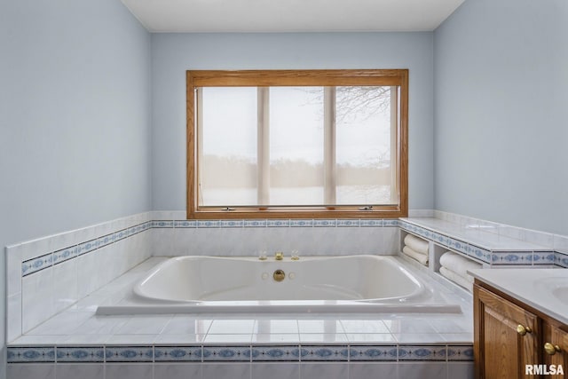 full bath featuring a stall shower, a garden tub, tile patterned flooring, and vanity