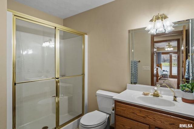 bathroom featuring ensuite bathroom, a shower stall, toilet, and vanity