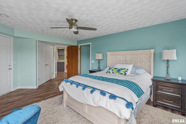 bedroom featuring wood finished floors, a ceiling fan, and baseboards