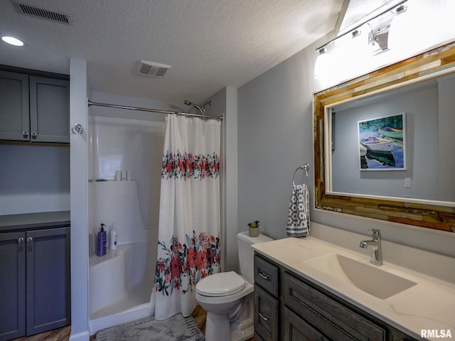 bathroom featuring curtained shower, toilet, a textured ceiling, vanity, and recessed lighting