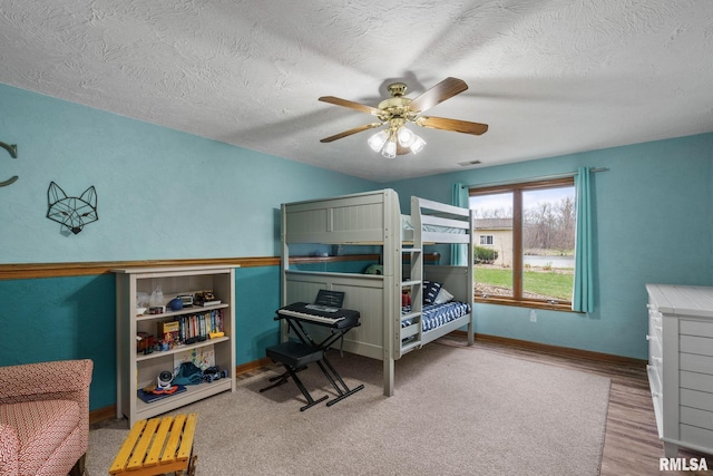 bedroom featuring wood finished floors, a closet, a textured ceiling, and ceiling fan