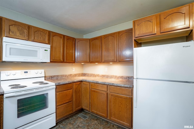 12855 Cleveland Ln, Pittsburg, IL 62974 - kitchen with visible vents, brown cabinetry, white appliances, and light countertops