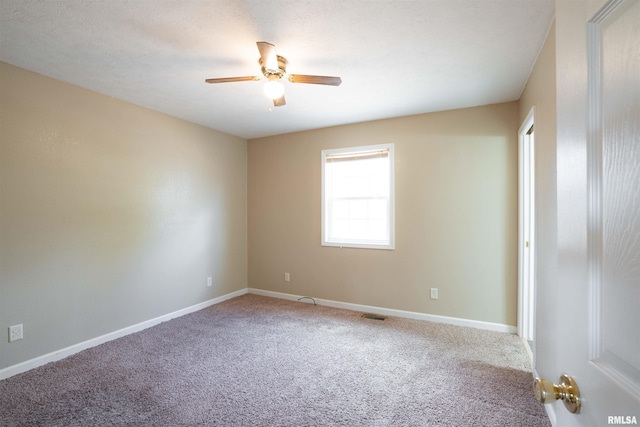 12855 Cleveland Ln, Pittsburg, IL 62974 - unfurnished room with visible vents, baseboards, a ceiling fan, and carpet flooring