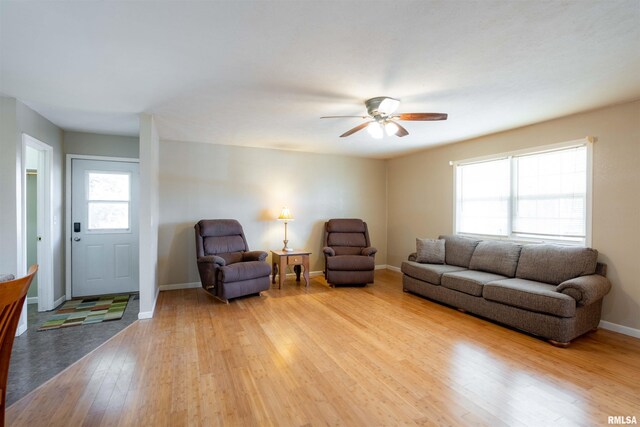 12855 Cleveland Ln, Pittsburg, IL 62974 - living area featuring light wood-style flooring, ceiling fan, baseboards, and a healthy amount of sunlight