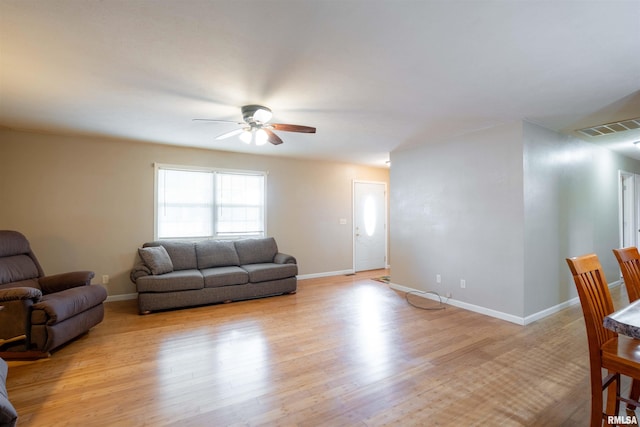 12855 Cleveland Ln, Pittsburg, IL 62974 - living area featuring visible vents, baseboards, light wood-type flooring, and a ceiling fan