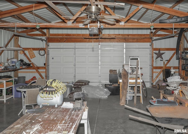 garage with metal wall, a garage door opener, and a ceiling fan