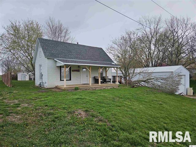 306 Walker St, Ursa, IL 62376 - view of front of home with roof with shingles, an outbuilding, covered porch, and a front yard