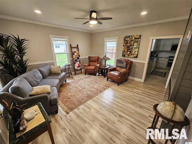 306 Walker St, Ursa, IL 62376 - living area featuring light wood-style flooring, ornamental molding, a ceiling fan, and recessed lighting