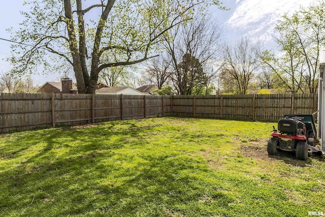 view of yard with a fenced backyard