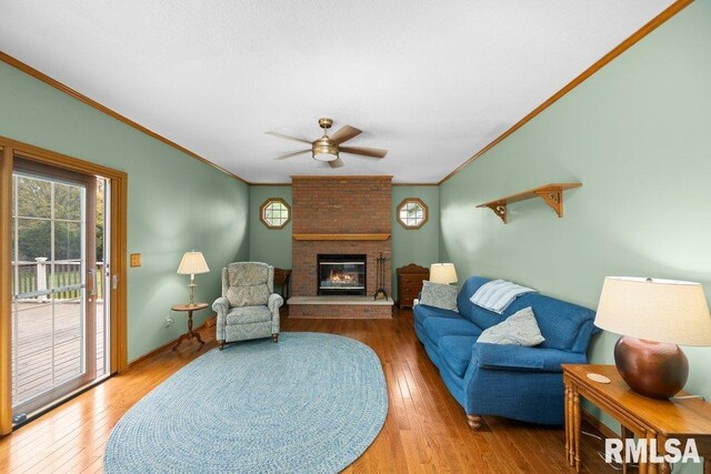 living room featuring crown molding, ceiling fan, and a wealth of natural light
