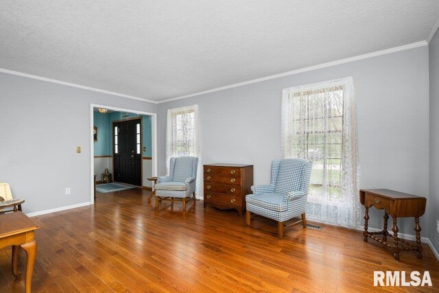 sitting room featuring a textured ceiling, plenty of natural light, and hardwood / wood-style floors