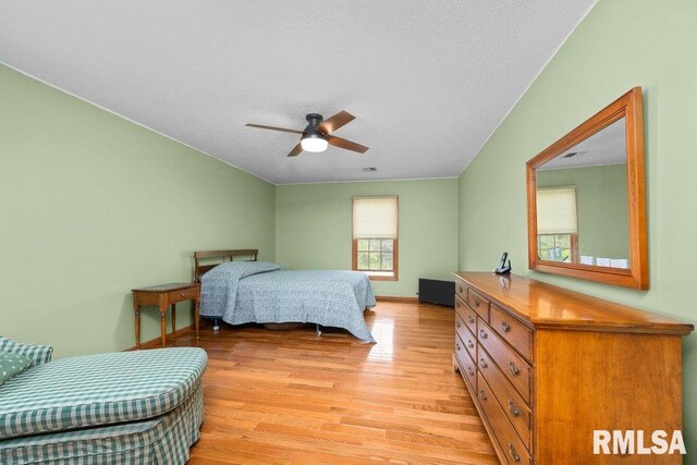 bedroom featuring a textured ceiling and light wood-style flooring