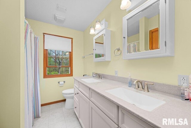 full bathroom with a sink, baseboards, toilet, and double vanity