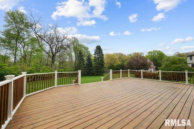 wooden terrace with a lawn