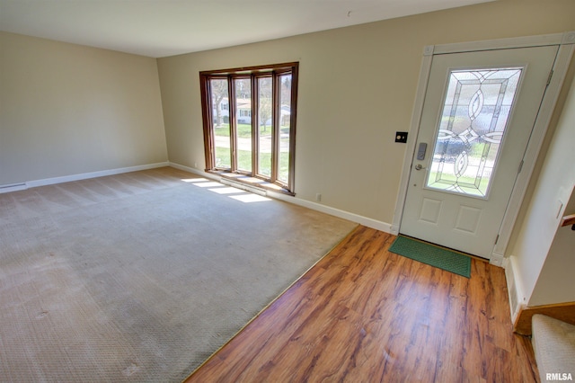 foyer featuring light wood-type flooring and baseboards