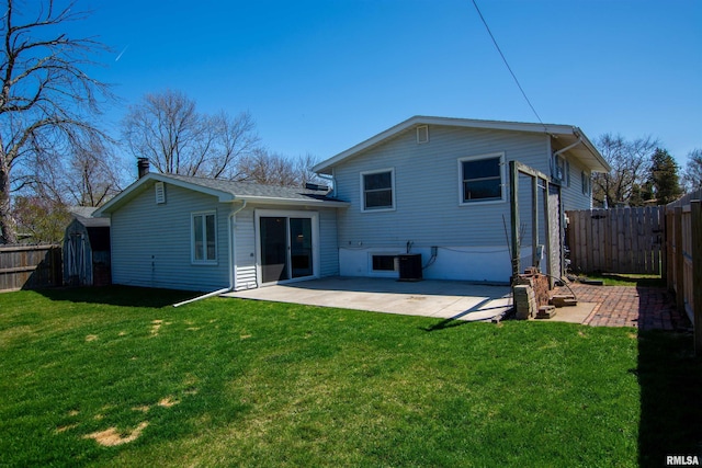 back of property featuring a patio area, a fenced backyard, and a lawn