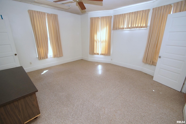 empty room with baseboards and ceiling fan