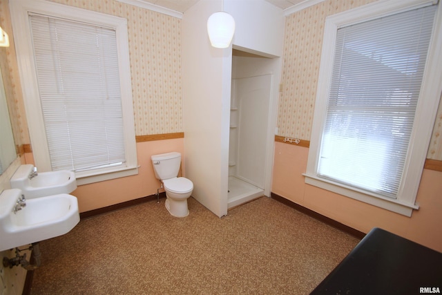 bathroom featuring baseboards, a stall shower, wallpapered walls, and toilet