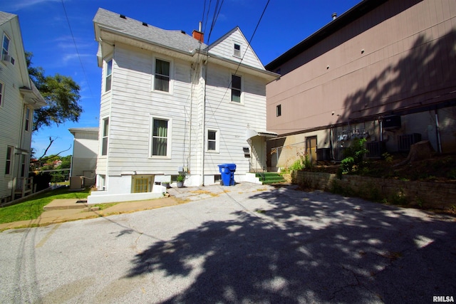 back of property featuring central AC unit