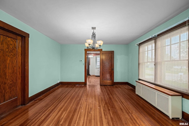 408 E Henry St, Atkinson, IL 61235 - unfurnished room with healthy amount of natural light, a chandelier, hardwood / wood-style flooring, and baseboards