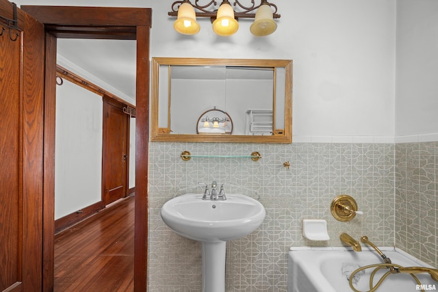 408 E Henry St, Atkinson, IL 61235 - full bathroom with a tub to relax in, wood finished floors, and tile walls