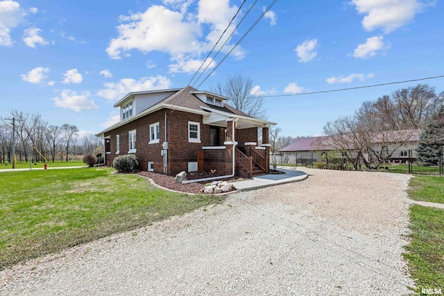 408 E Henry St, Atkinson, IL 61235 - view of side of property featuring a porch, brick siding, and a yard