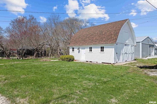 408 E Henry St, Atkinson, IL 61235 - view of side of home featuring roof with shingles, an outbuilding, a yard, and a shed