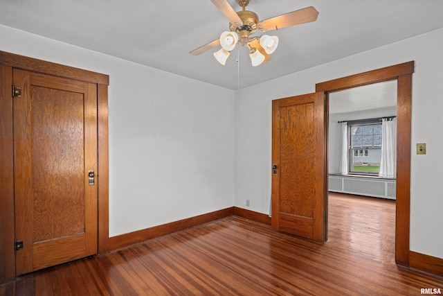 408 E Henry St, Atkinson, IL 61235 - spare room with wood finished floors, radiator heating unit, baseboards, and ceiling fan