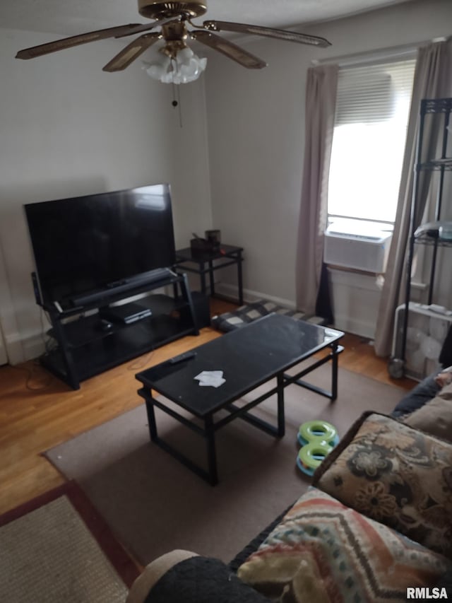 living area with ceiling fan and wood finished floors