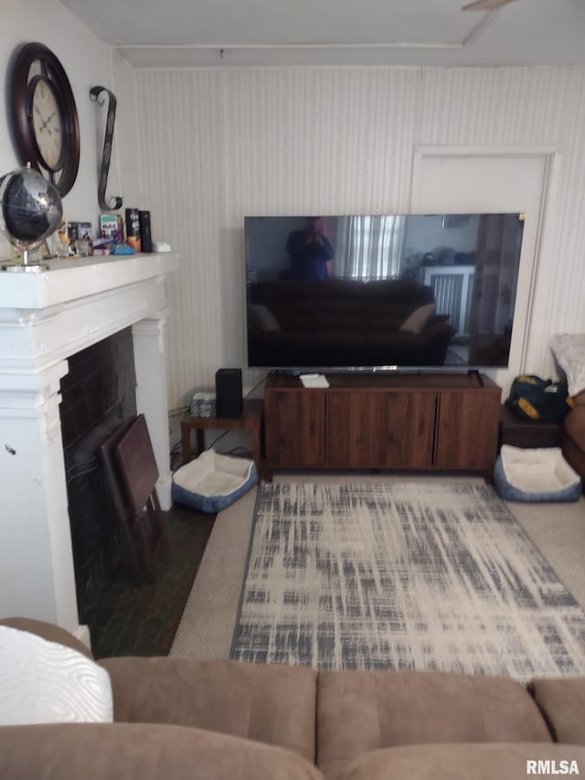 living room featuring ceiling fan, carpet, and a healthy amount of sunlight