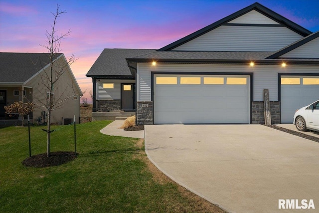 view of front of home with concrete driveway, stone siding, and a garage
