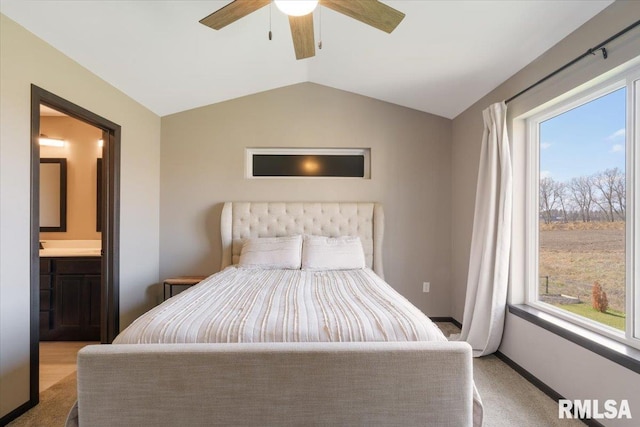 carpeted bedroom featuring ensuite bathroom, baseboards, a ceiling fan, and lofted ceiling