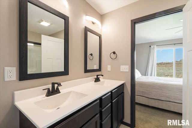 bathroom with a sink, ensuite bathroom, and double vanity
