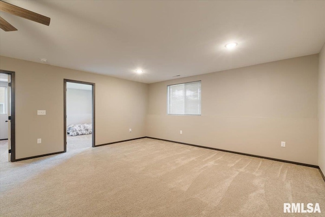 spare room featuring ceiling fan, light colored carpet, baseboards, and recessed lighting