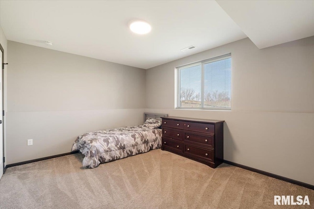 bedroom featuring light colored carpet, baseboards, and visible vents
